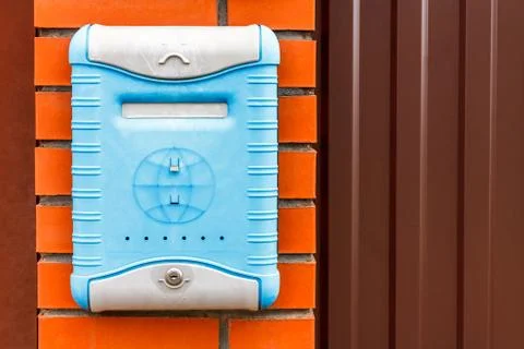 A beautiful mailbox hangs waiting for newspapers, parcels and letters. Stock Photos