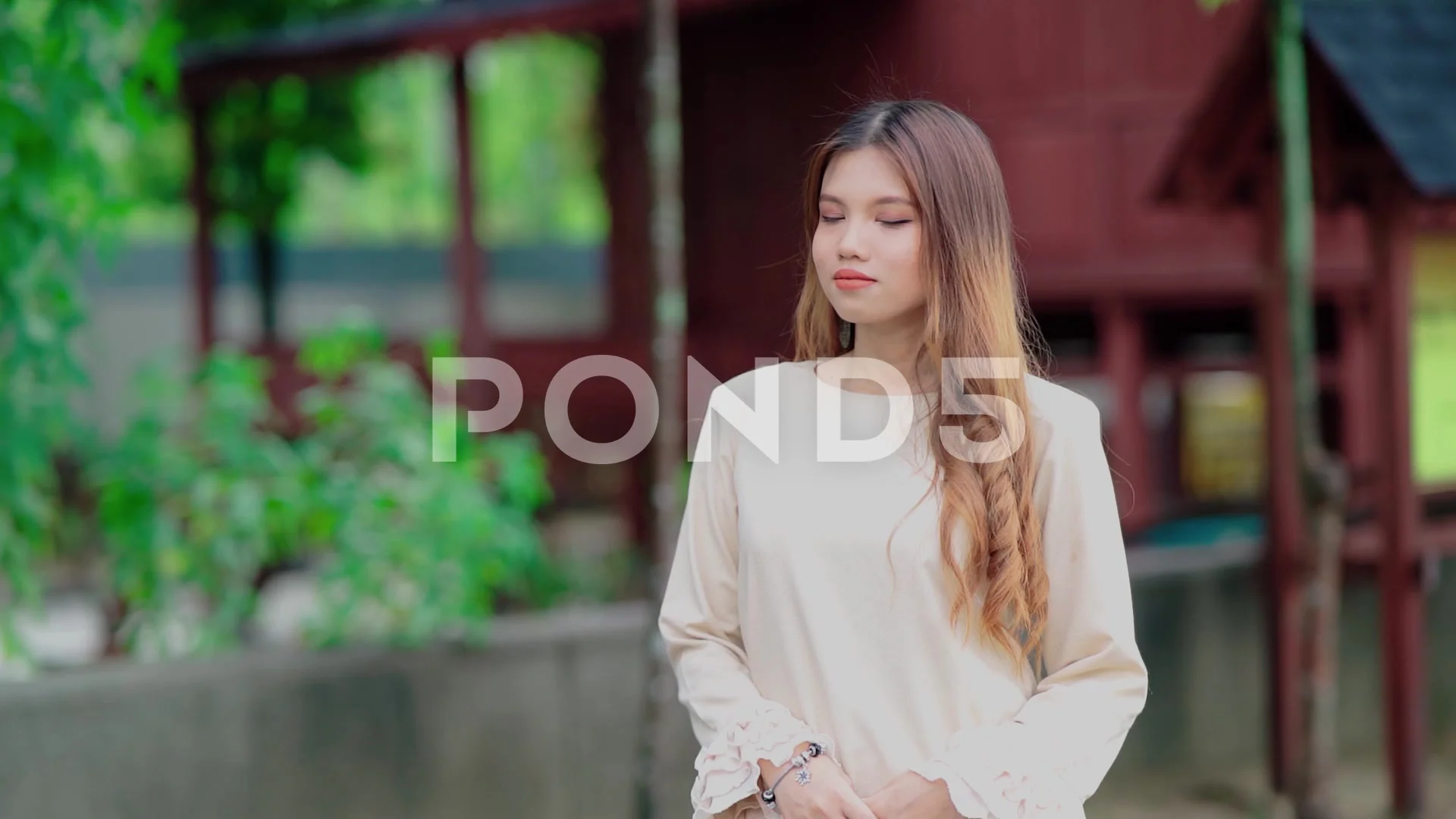 beautiful malay girl with malay house in the background