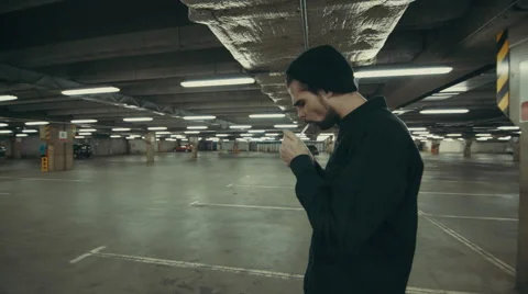 Beautiful man goes somewhere in the Parking lot Stockbeeldmateriaal 56270584