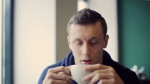 Beautiful man looking into the camera in cafe Stock Footage 57228618