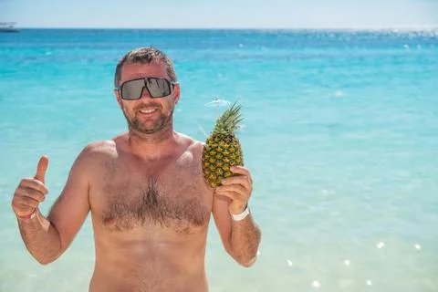 Beautiful man with pineapple cacktail Stock Photos