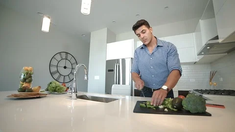 A beautiful man is preparing to eat in the kitchen Stock Footage 100576181