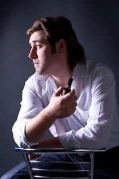Beautiful man smoking a pipe Stock Photos