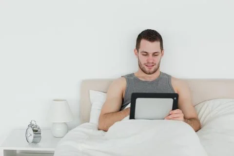 Beautiful man using a tablet computer Stockfoto's