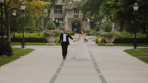 A beautiful married couple walking down the park and holding their hands. Stock Footage 103951489