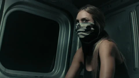 Beautiful masked robber in a van Stock Footage 264575863
