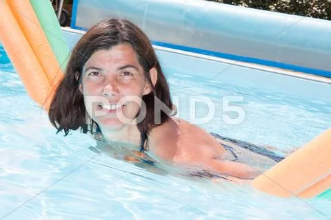 Beautiful middle-aged woman in the pool Stock Photos