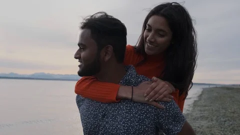 Beautiful middle eastern couple hugging on beach Stock Footage 111977064