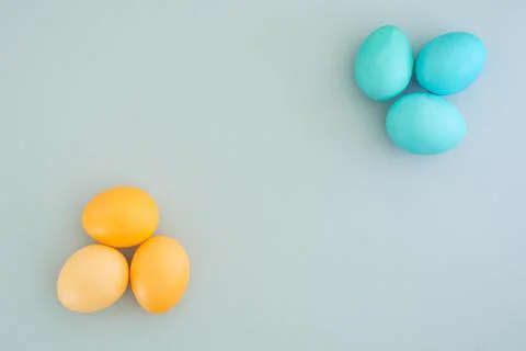 Beautiful minimalistic easter background with painted yellow and blue eggs with Stock Photos
