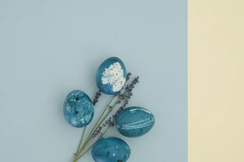 Beautiful minimalistic easter background with painted eggs and lavender branches Stock Photos