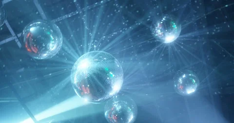 Beautiful mirror balls rotates under the ceiling. Night disco party concept Stock Footage 128355907
