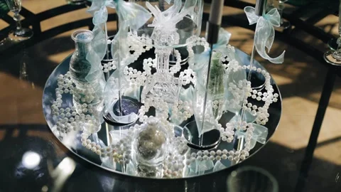 The beautiful mirrored table is decorated with various decorations Stock Footage 336659544