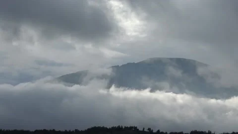 Beautiful mists dancing back and forth in front of mountain timelapse Stock Footage 159074172