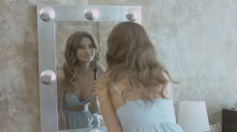 Beautiful model applying powder to the face using brush and standing in front of Video stock 63790308