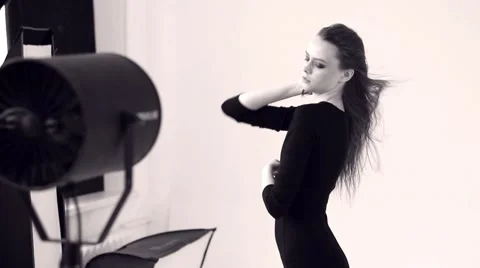 Beautiful model dances in front of the fan Stock Footage 60246667