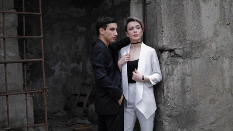 Beautiful model fixes jacket and poses with handsome partner Stock Footage 115236103