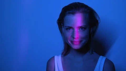 Beautiful Model in Front of Wall Laughing While Inside Dark Room Video stock 115508247