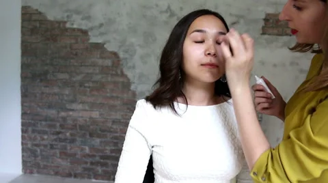 Beautiful model gets a professional makeup done by a visagist. Super video Stock Footage 65206830
