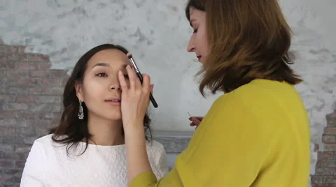 Beautiful model gets a professional makeup done by a visagist. Super video Stock Footage 65207586