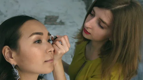 Beautiful model gets a professional makeup done by a visagist. Super video Stock Footage 65207949