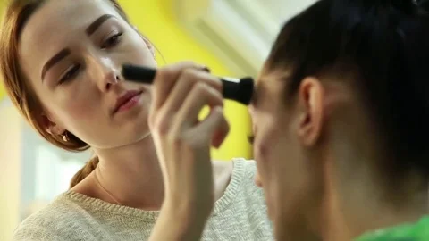 Beautiful model gets a professional makeup done by a visagist. Close-up. Stock Footage 74350227