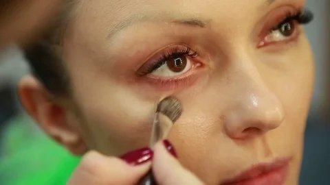 Beautiful model gets a professional makeup done. Close up Stock Footage 74350231