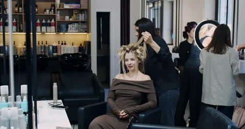 A Beautiful Model Getting Ready at a Modern Salon, Embracing a Chic and Elegant Stock Footage 318280695