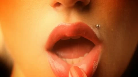 Beautiful model plays with her red lips Stock Footage 10584121