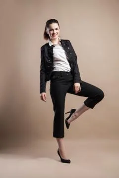 Beautiful model posing on beige background . studio photo Stock Photos