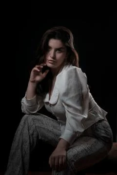 Beautiful model posing over black background, portrait Stock-Fotos