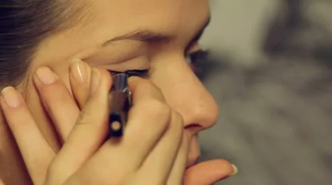 Beautiful model put make up- close up-eye liner. Stock-Footage 10063179