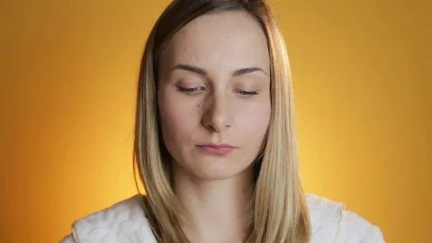 Beautiful model putting face cream on on yellow background Vídeos de archivo 71893956