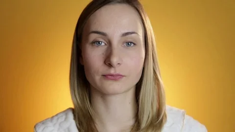 Beautiful model putting face cream on on yellow background Stock Footage 71894291
