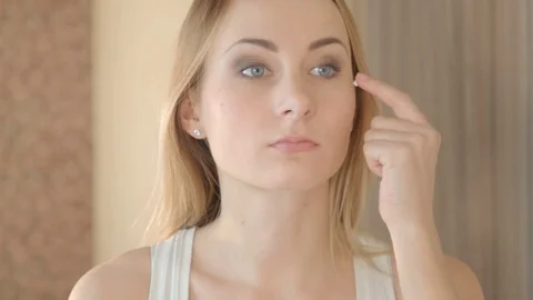 Beautiful model putting face cream in bathroom Video stock 72123313