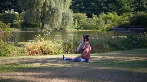 Beautiful model on smartphone in front of lake - wide Stock Footage 40293760