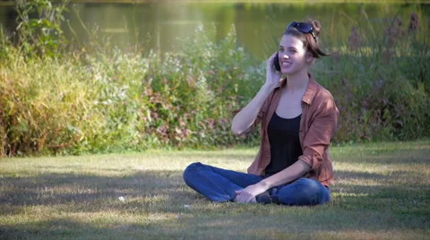 Beautiful model on smartphone in front of lake - medium Stock Footage 40295059
