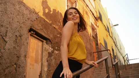 Beautiful Model on the Steps of Stairs Smiling While Holding on Rails 스톡 동영상 115846670