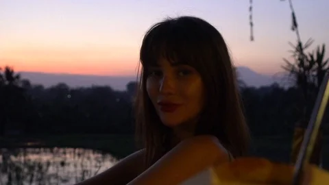 Beautiful model on a sunset background in a village in a rice field. Stock Footage 113607056