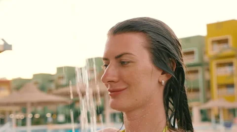 Beautiful model takes a shower by the pool. HD Stock Footage 67174133