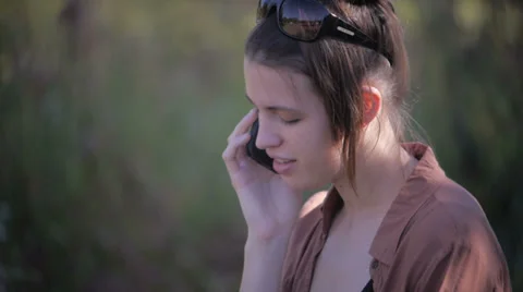 Beautiful model talking on smartphone - medium close up shot Stock Footage 34512756