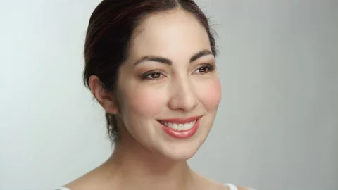Beautiful model on white background smiles broadly with teeth while posing Stock Footage 193929838