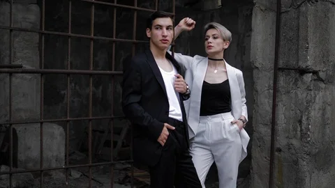 Beautiful models pose at old brown rusty grate and grey wall Stock Footage 115235122