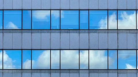 Beautiful modern tall tower with clouds in financial district. Windows skylin Ilustración de archivo