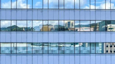 Beautiful modern tall tower with clouds in financial district. Windows skylin Ilustración de archivo
