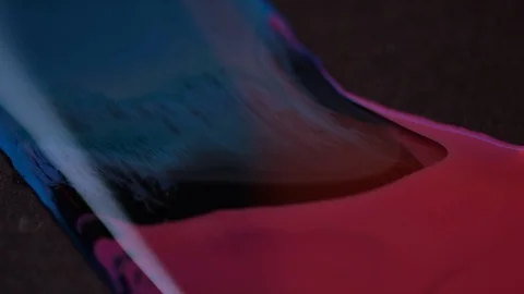 Beautiful motion of red and blue watercolor mixing shown in macro shot Stock Footage 101733293