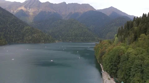 Beautiful mountain blue lake surrounded by coniferous forest Stock Footage 144645295