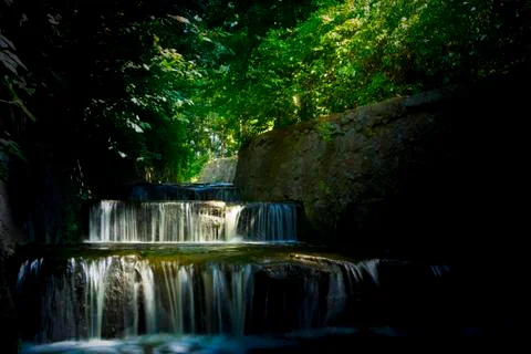 Beautiful mountain forest stream, with reflection in water Stock Photos