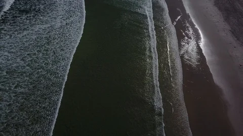 Beautiful Mountain Range Behind Waves Crashing On Beach [Drone Footage] Stock Footage 91040652