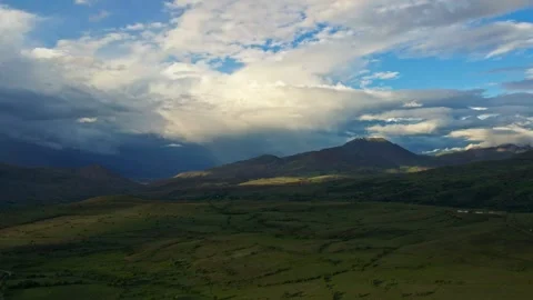 A beautiful mountain range with a cloudy sky in the background Stock Footage 327923699