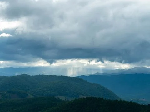 Beautiful mountain range landscape timelapse with low clouds moving in twilight. 스톡 사진